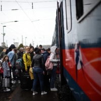 Ukrainian refugees board a train taking them back into Ukraine at the Zahony train station along the Ukrainian-Hungarian border on April 9. | AFP-JIJI