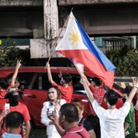 Supporters of Ferdinand Marcos Jr. outside his campaign headquarters in Manila on Monday.  | BLOOMBERG