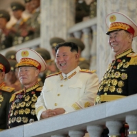 North Korean leader Kim Jong Un watches a nighttime military parade to mark the 90th anniversary of the founding of the Korean People\'s Revolutionary Army, in Pyongyang, in this undated photo released April 26. | KCNA / VIA REUTERS   