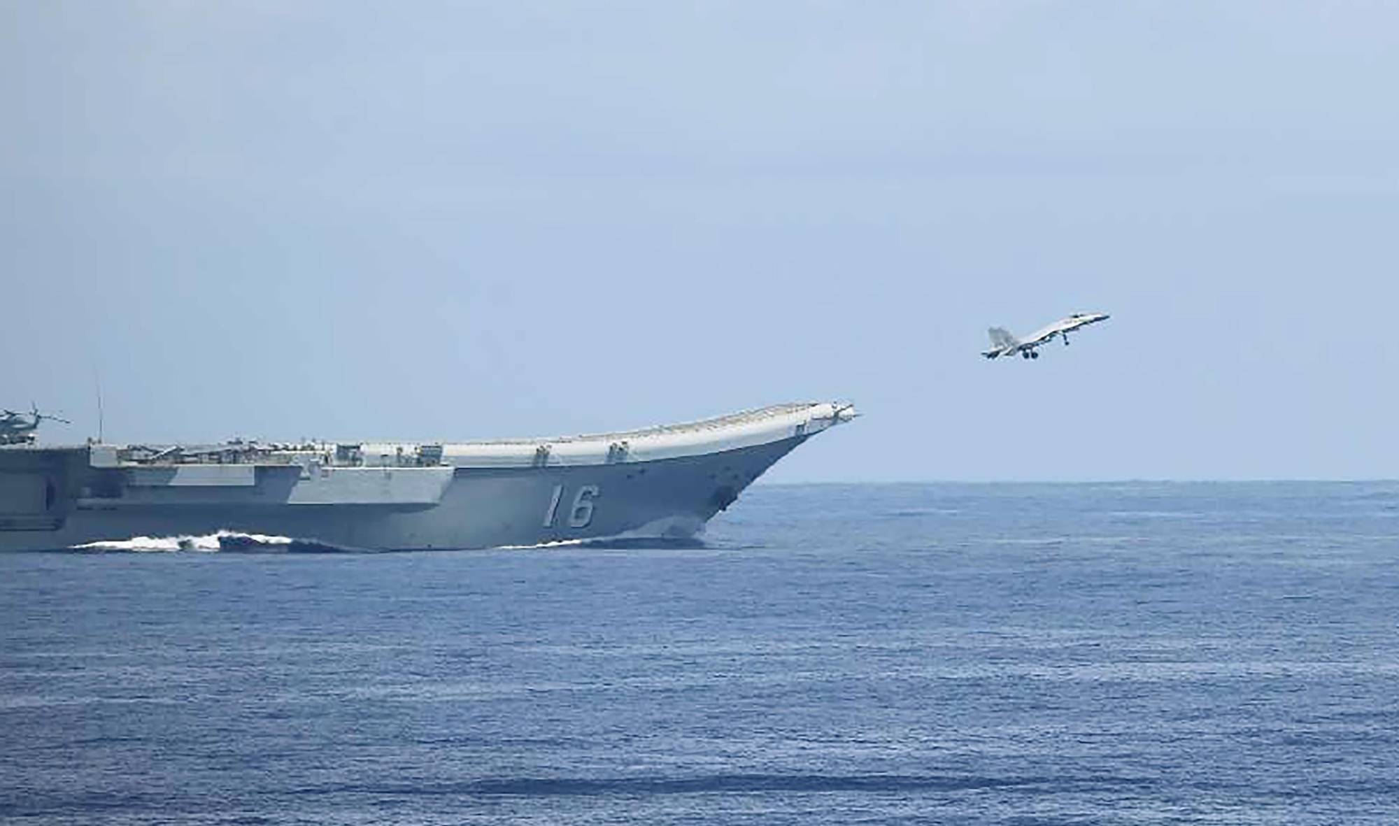 A fighter jet takes off from China's Liaoning aircraft carrier in waters south of Okinawa Prefecture's Ishigaki Island on Sunday. | DEFENSE MINISTRY JOINT STAFF OFFICE / VIA KYODO