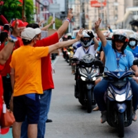 Supporters of Ferdinand Marcos Jr. celebrate outside his headquarters in the city of Mandaluyong, the Philippines, on Tuesday. | REUTERS 