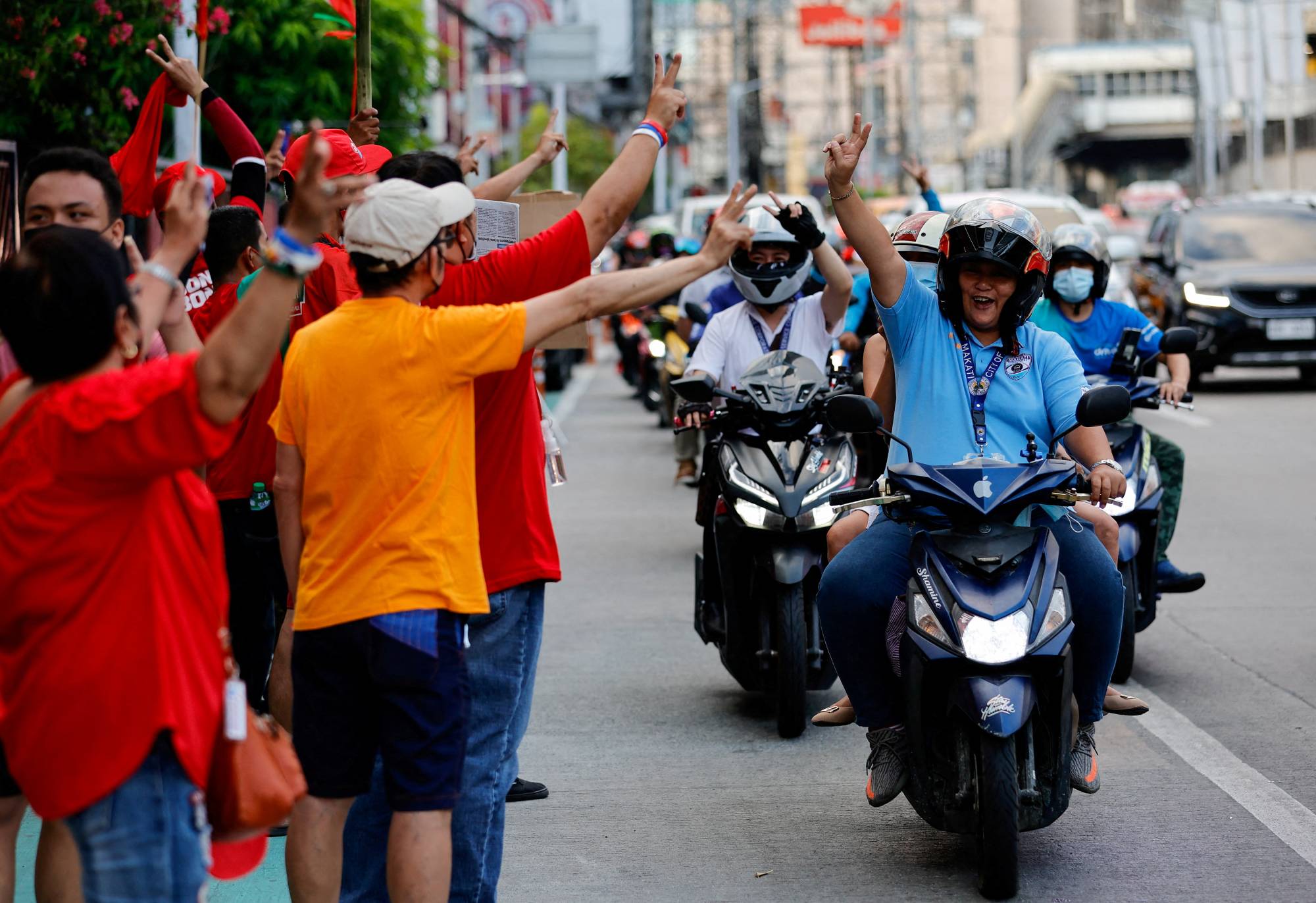 Supporters of Ferdinand Marcos Jr. celebrate outside his headquarters in the city of Mandaluyong, the Philippines, on Tuesday. | Reuters 