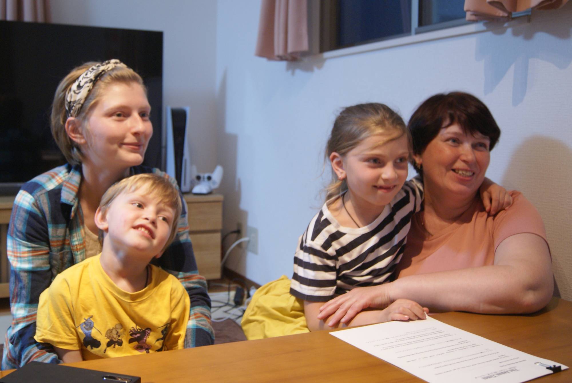 Anastasiia Kriachko (back left), Matvii (front left), Rehina (center right) and Maiia Kriachko in Tokyo's Shinjuku Ward in April. Maiia and her two young children joined her adult daughter in Japan after Russia's invasion of Ukraine. | CHRIS RUSSELL