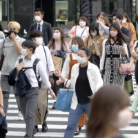 Chief Cabinet Secretary Hirokazu Matsuno said Wednesday that people don\'t always have to wear masks outdoors if they can conduct social distancing. | KYODO