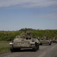 A column of Ukrainian troops in armored personnel carriers near the frontline in the Donetsk region of Ukraine on Thursday. | LYNSEY ADDARIO / THE NEW YORK TIMES
