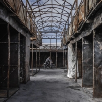 A cyclist rides through a market destroyed by shelling in Kharkiv, Ukraine, on Thursday. Ukrainian and Western officials say that Russia is reportedly withdrawing forces from around Ukraine’s second-largest city where it has been losing territory. | FINBARR O\'REILLY / THE NEW YORK TIMES
