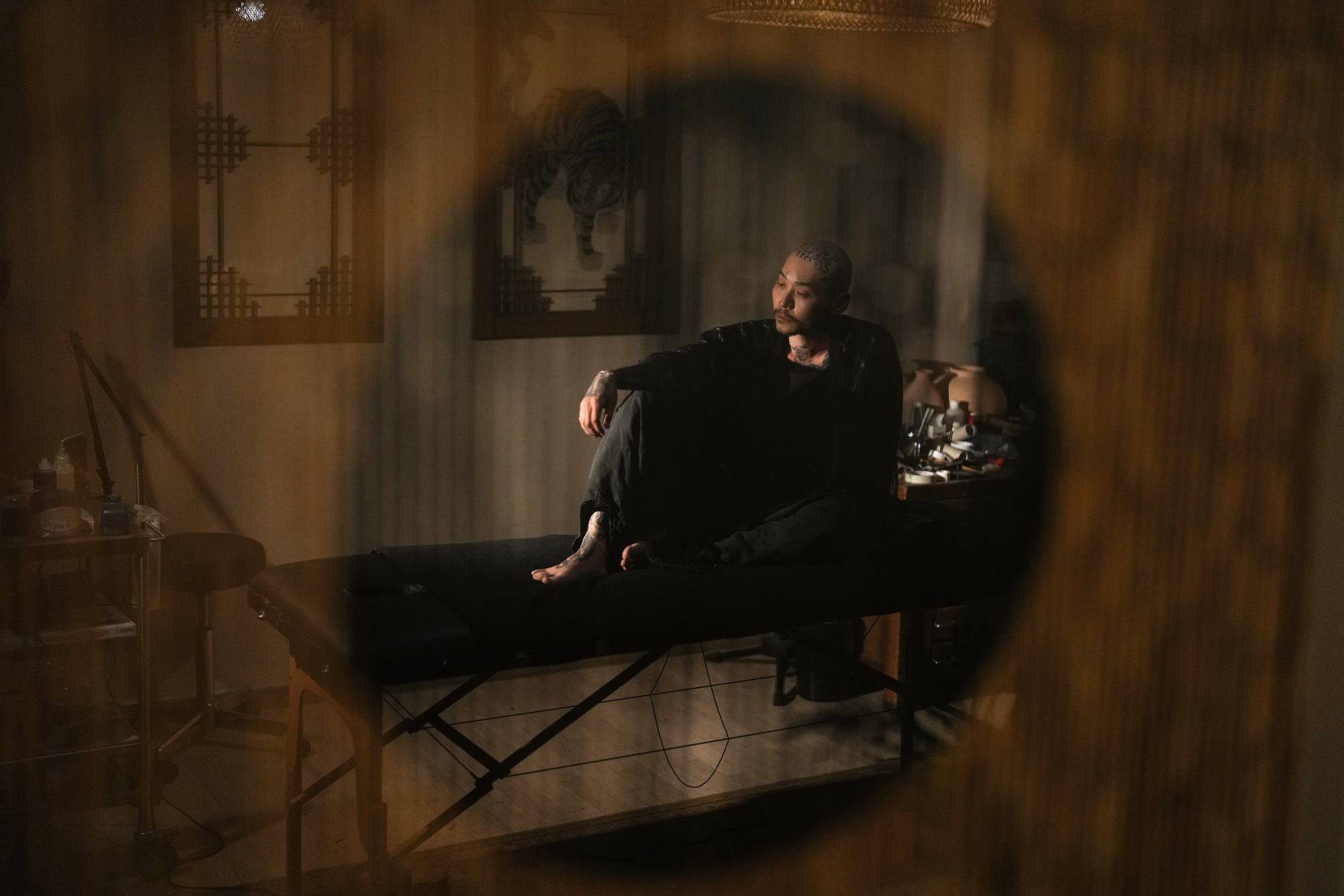 Apro Lee, a tattoo artist, at his studio in a city an hour north of Seoul on May 2. Tattoo artists, long treated as criminals for their work, say that it is time to end the stigma against their business, which has thrived underground. | Chang W. Lee/The New York Times