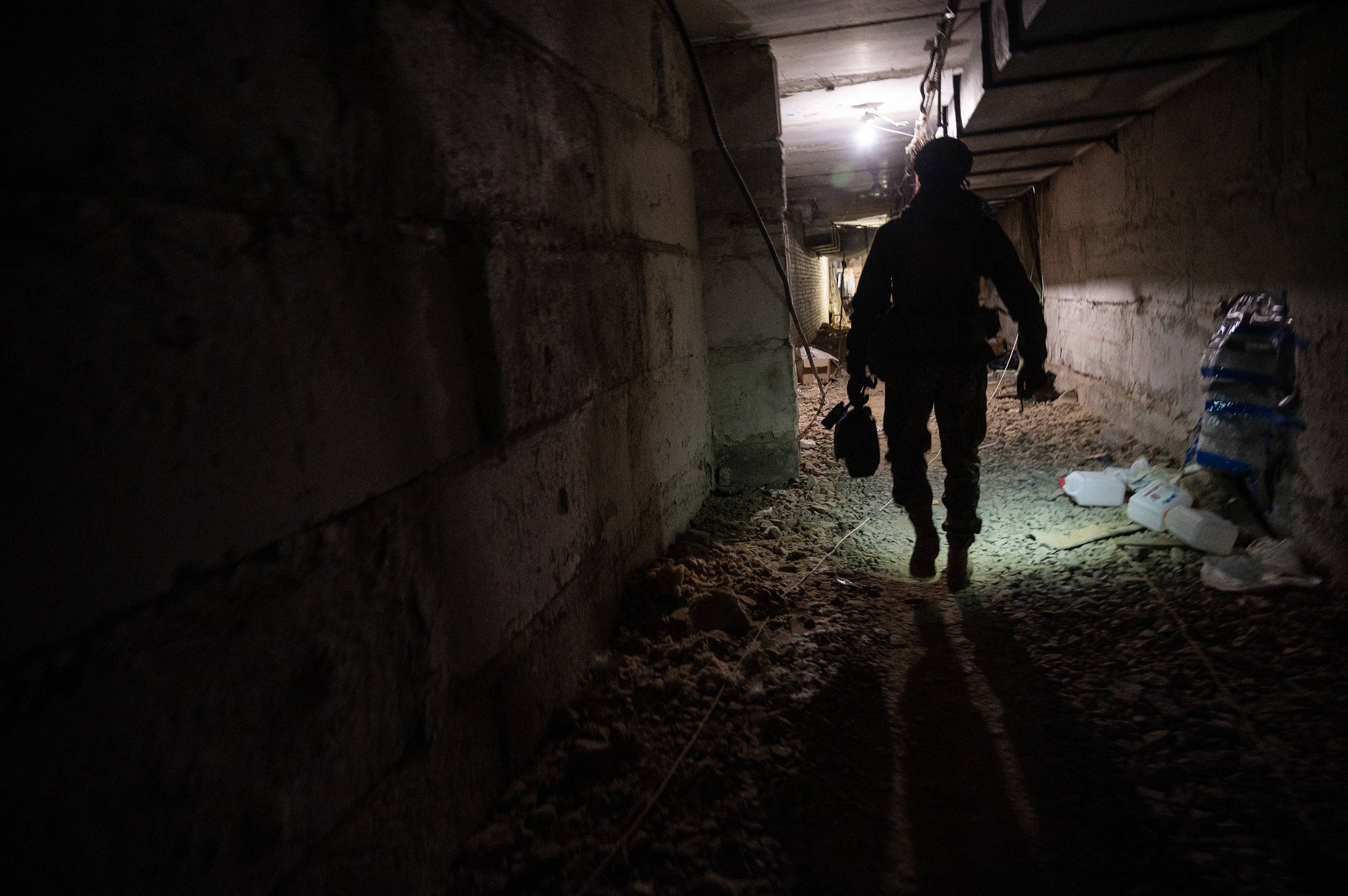A soldier of the Ukrainian Army’s Carpathian Sich Battalion walks through an underground base in the Kharkiv region of Ukraine on Wednesday. The volunteer unit is deployed along a line of villages and trenched farmland in the Kharkiv region, tasked with holding back Russian forces pushing down from their stronghold in the occupied Ukrainian city of Izium. | Lynsey Addario/The New York Times