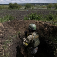 A Ukrainian serviceman in a trench used as an observation point in a front-line area of Ruska Lozova, a village retaken by the Ukrainian forces, in the Kharkiv region on Sunday.  | REUTERS 