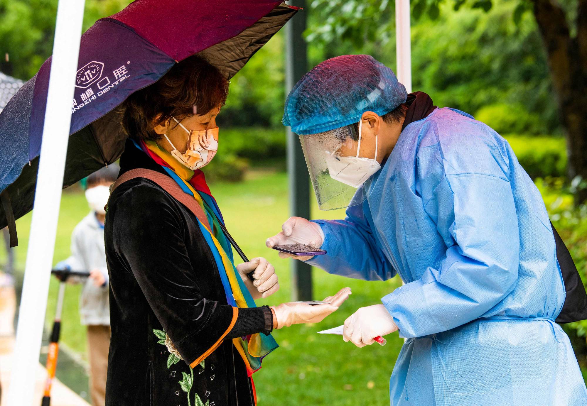 A resident registers for a COVID-19 test at a compound under lockdown in Shanghai on Friday. | AFP-Jiji