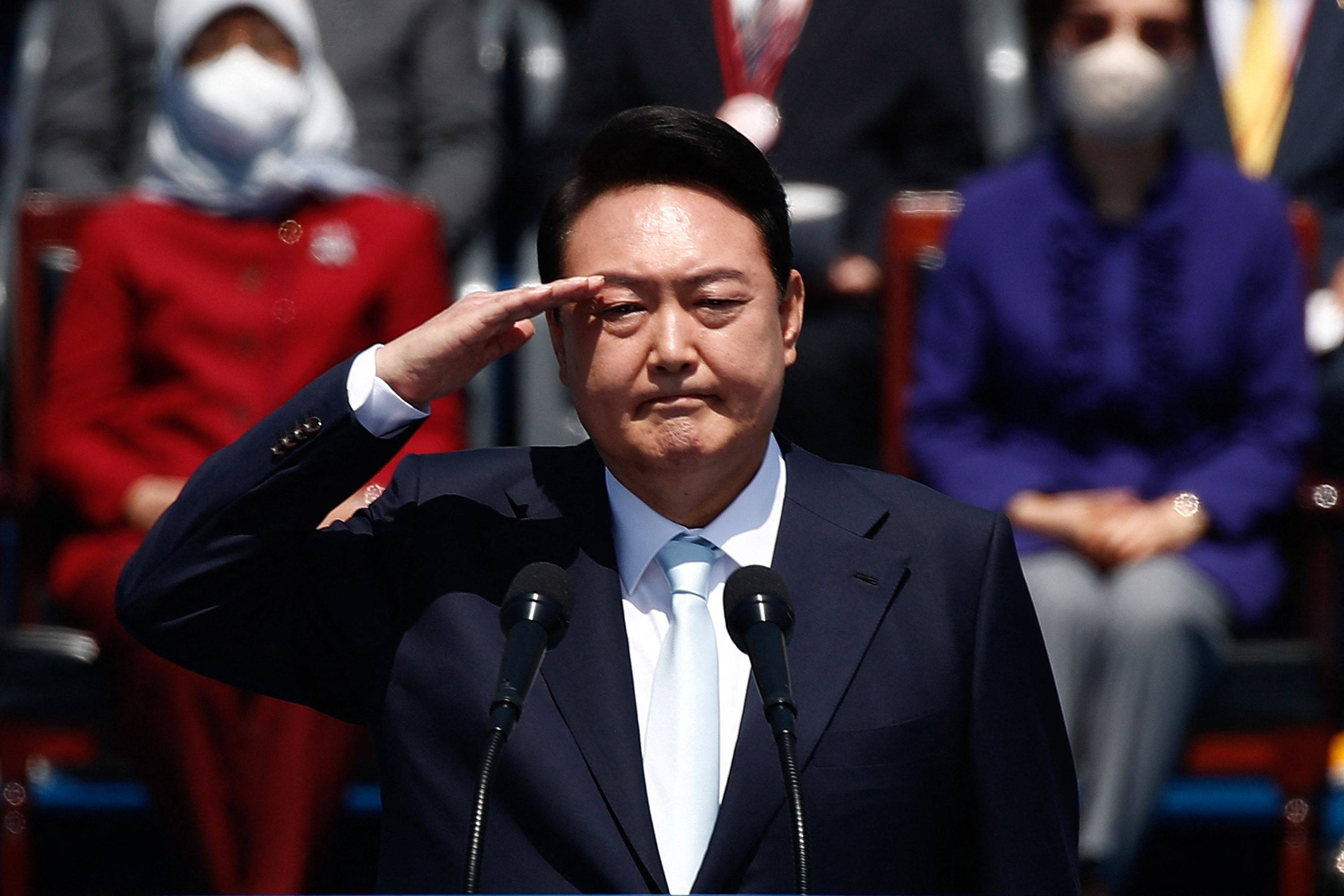 South Korean President Yoon Suk-yeol salutes during his inauguration in front of the National Assembly in Seoul on May 10. | Pool / AFP-Jiji