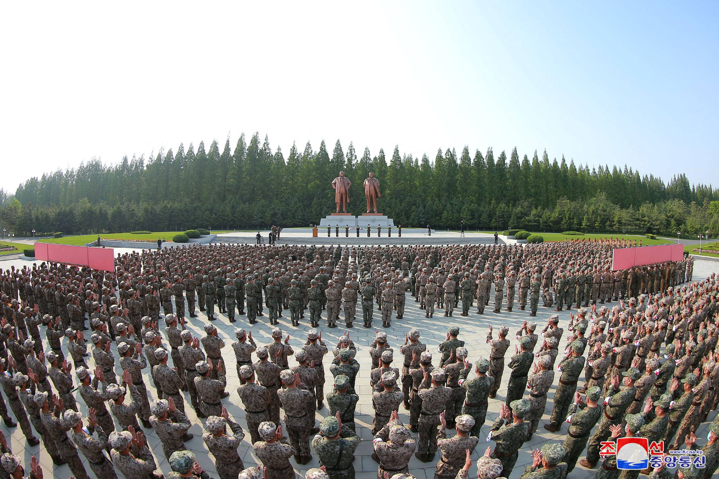 In this photo released Tuesday, military personnel from the Korean People's Army medical corps attend the launch of a campaign in Pyongyang to improve the supply of medicine amid an outbreak of COVID-19. | KCNA / via Reuters 