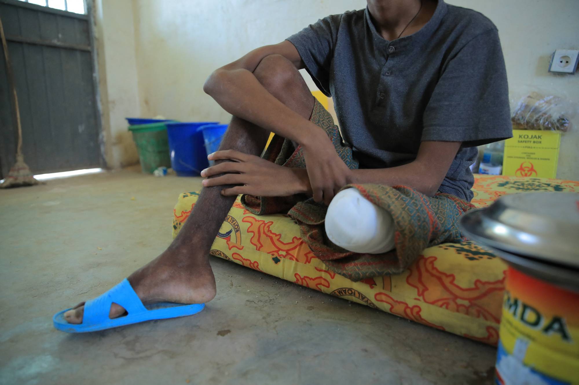 Filimon, 18, a captured fighter from the Tigray People's Liberation Front, sits in a guarded hospital room in Dubti Referral Hospital in Ethiopia on Feb. 24 | REUTERS