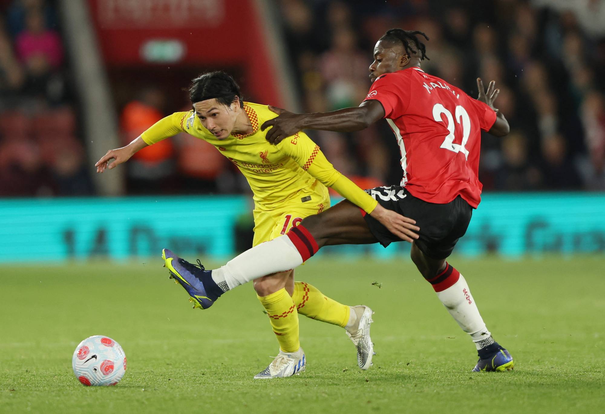 Liverpool's Takumi Minamino contends for the ball with Southampton's Mohammed Salisu during their Premier League game in Southampton, England, on Tuesday. | REUTERS