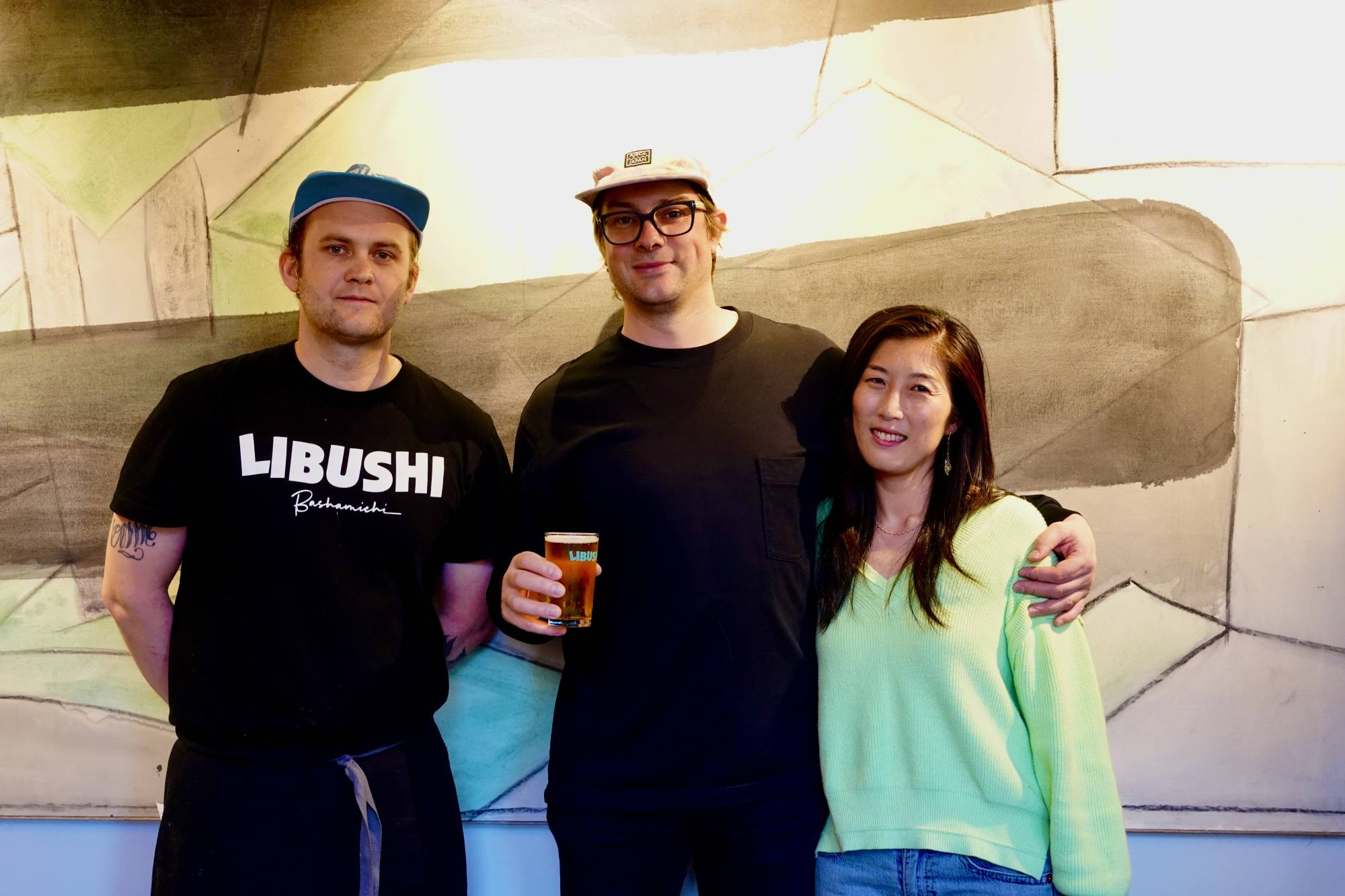 Tom and Emi Livesey (center, right) are setting the standard high at their new taproom in Yokohama, thanks to the eclectic cuisine of chef James Buckley (left). | ROBBIE SWINNERTON