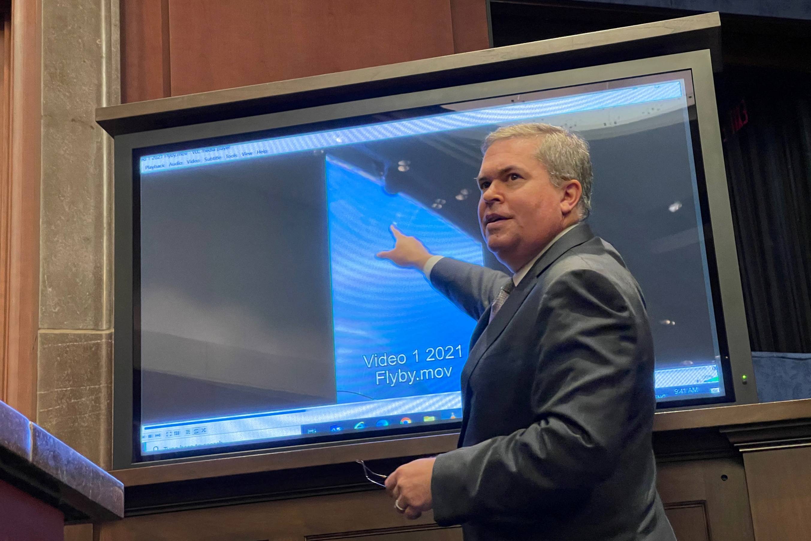 Scott Bray, deputy director of U.S. Naval Intelligence, points to a video of a 'flyby' as he testifies before a congressional committee hearing about unidentified aerial phenomena, on Capitol Hill in Washington on Tuesday.  | REUTERS 