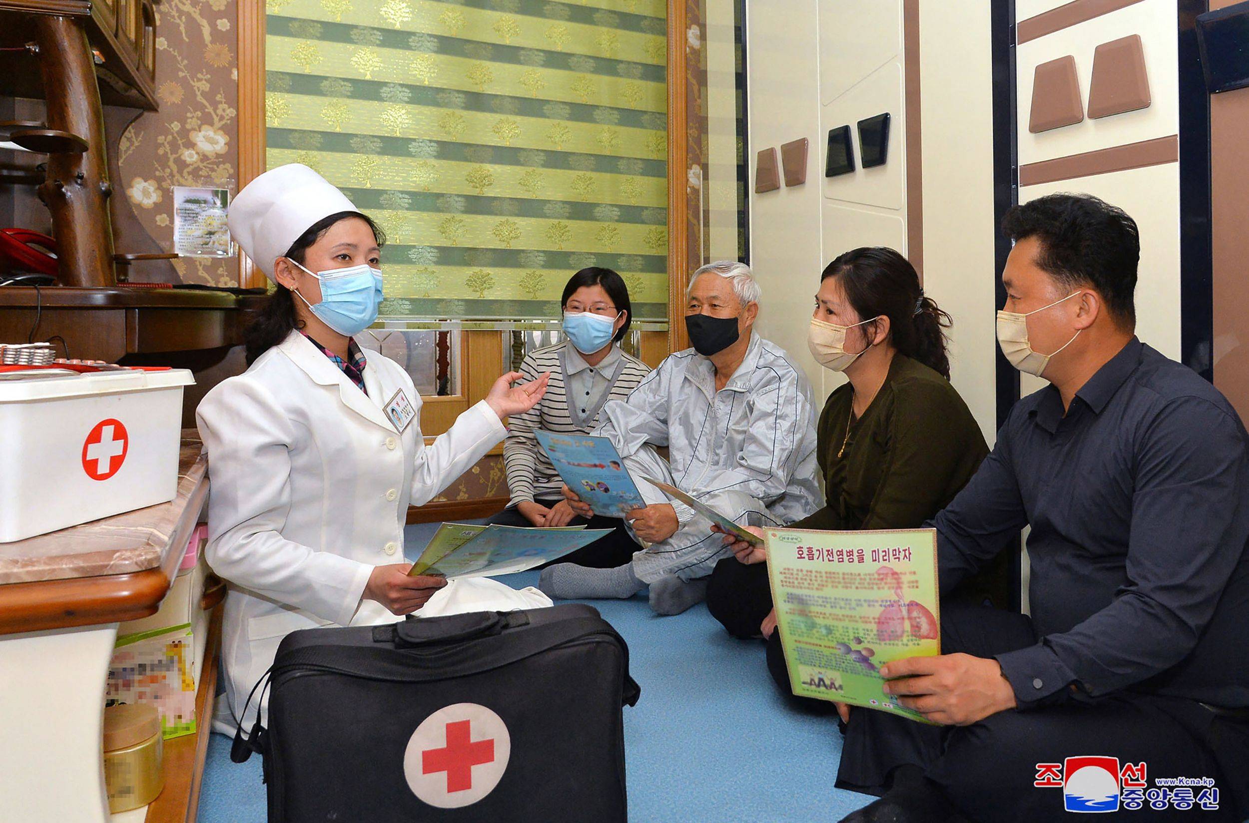 A doctor promoting epidemic prevention measures to prevent the spread of the COVID-19 in Pyongyang on Tuesday. | KCNA / VIA KNS / AFP-JIJI