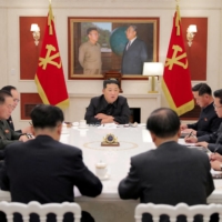 North Korean leader Kim Jong Un (center) presides over a politburo meeting of the ruling Workers\' Party, amid a COVID-19 outbreak, in Pyongyang, on Tuesday. | KCNA / REUTERS