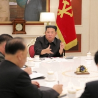 North Korean leader Kim Jong Un (center) presides over a politburo meeting of the ruling Workers\' Party, amid a COVID-19 outbreak, in Pyongyang, on Tuesday. | KCNA / REUTERS