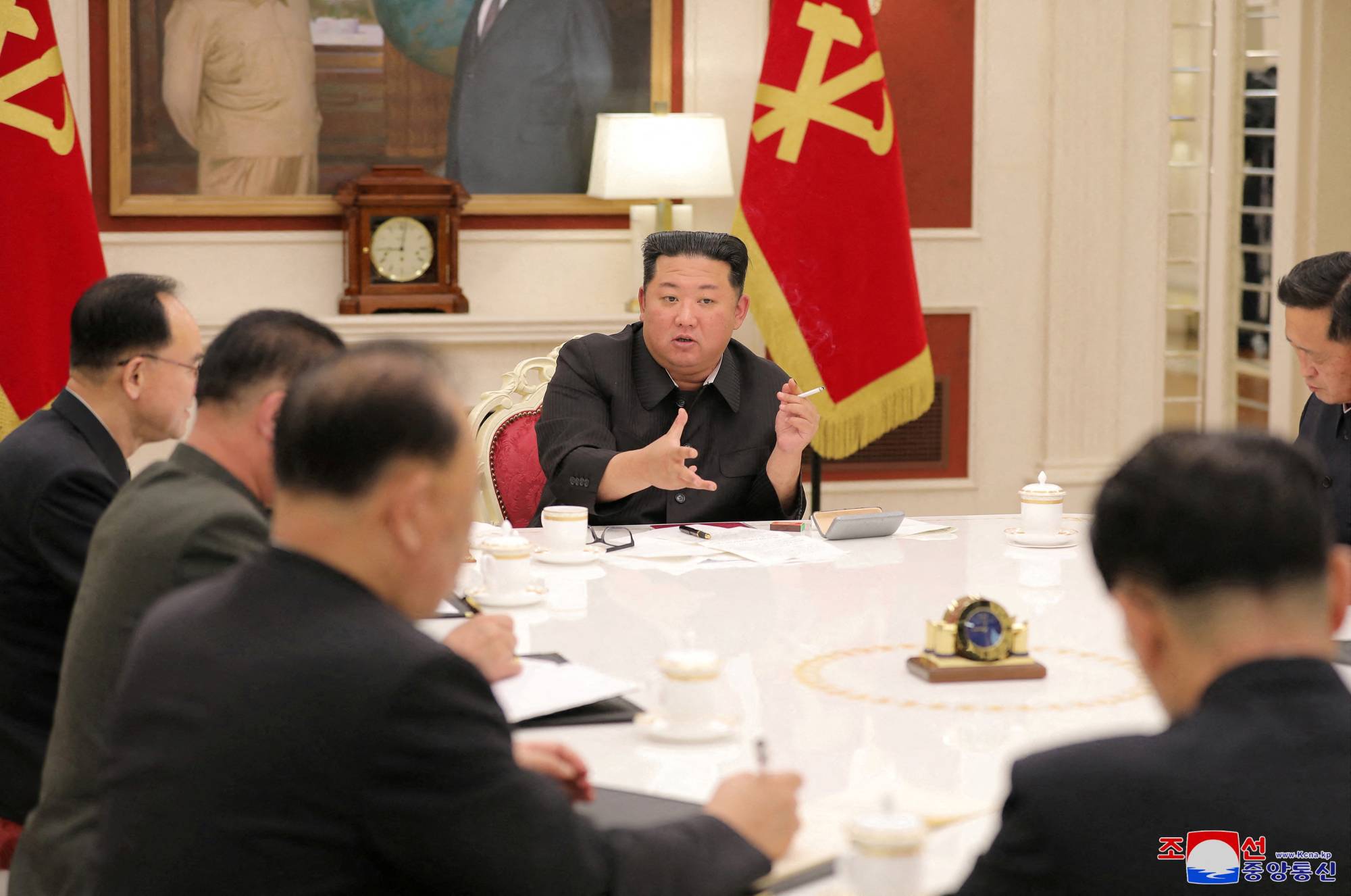 North Korean leader Kim Jong Un (center) presides over a politburo meeting of the ruling Workers' Party, amid a COVID-19 outbreak, in Pyongyang, on Tuesday. | KCNA / Reuters