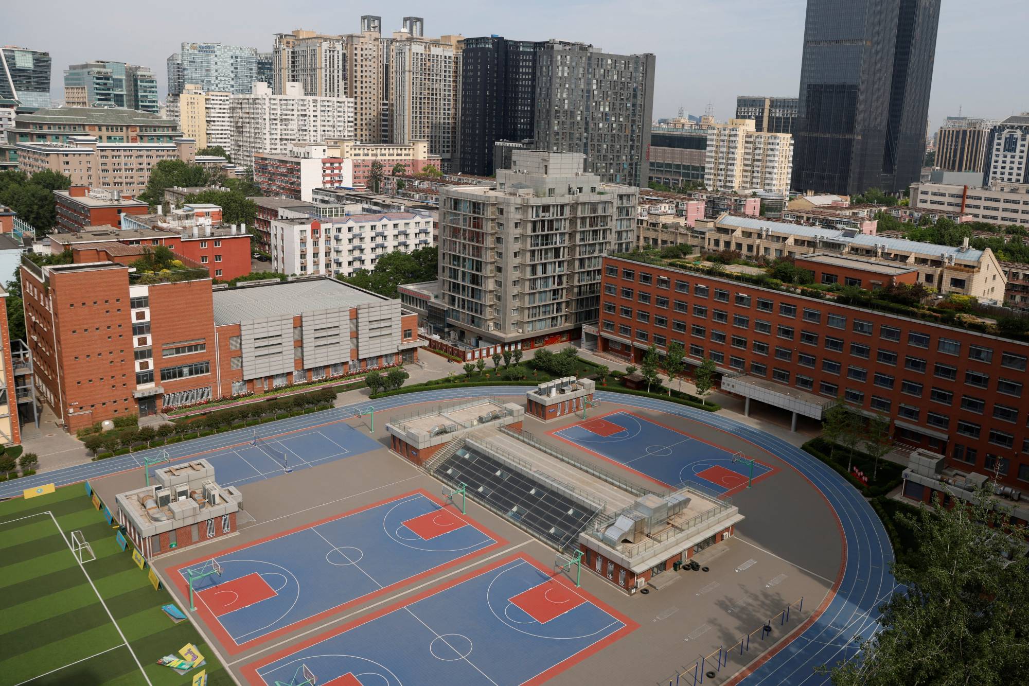 The sports field of a Chinese high school with an international students department in Beijing on Wednesday. In addition to teachers departing, international schools face a drop in foreign student enrollment as the COVID-19 curbs have led many foreign families to leave, while others stay away. | REUTERS