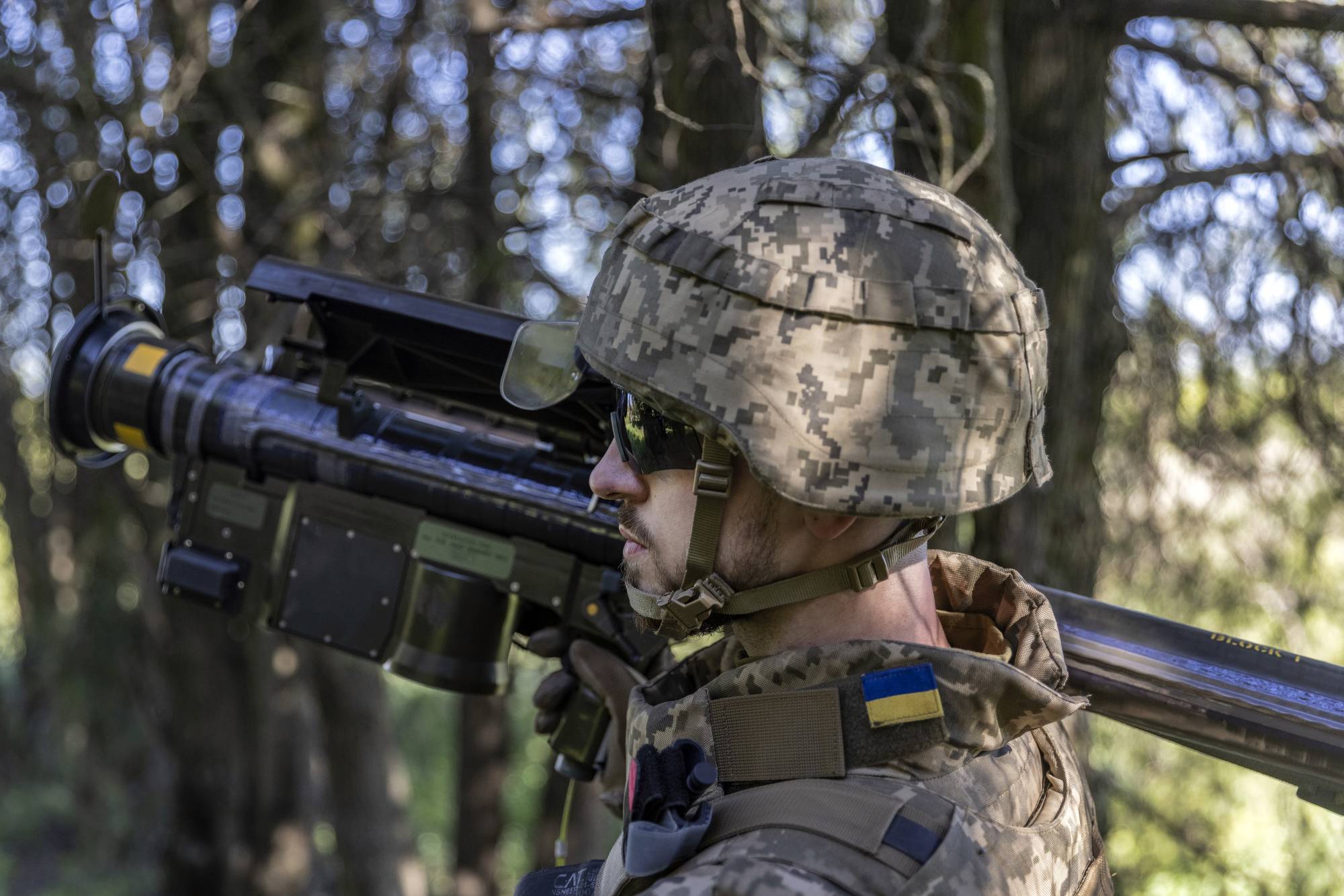 A Ukrainian soldier carries a U.S.-made Stinger missile launcher at a short-range artillery position in the Kherson region of southern Ukraine on May 6. | David Guttenfelder / The New York Times