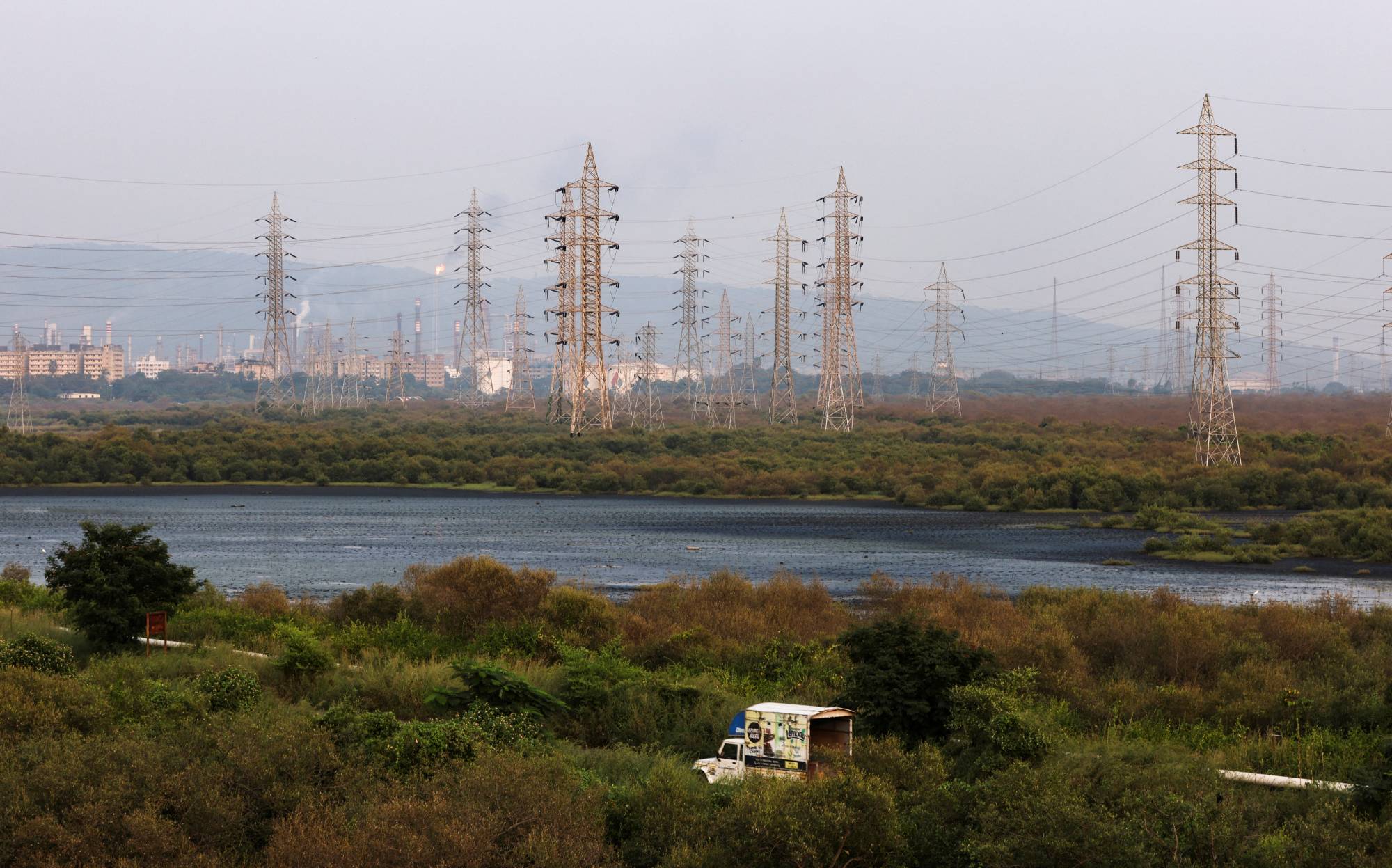 Electricity pylons in Mumbai. Analysts and experts have cautioned that grids may remain under pressure for years, with midday peak demand adding to persistent high use during the night when solar power supplies drop off. | REUTERS