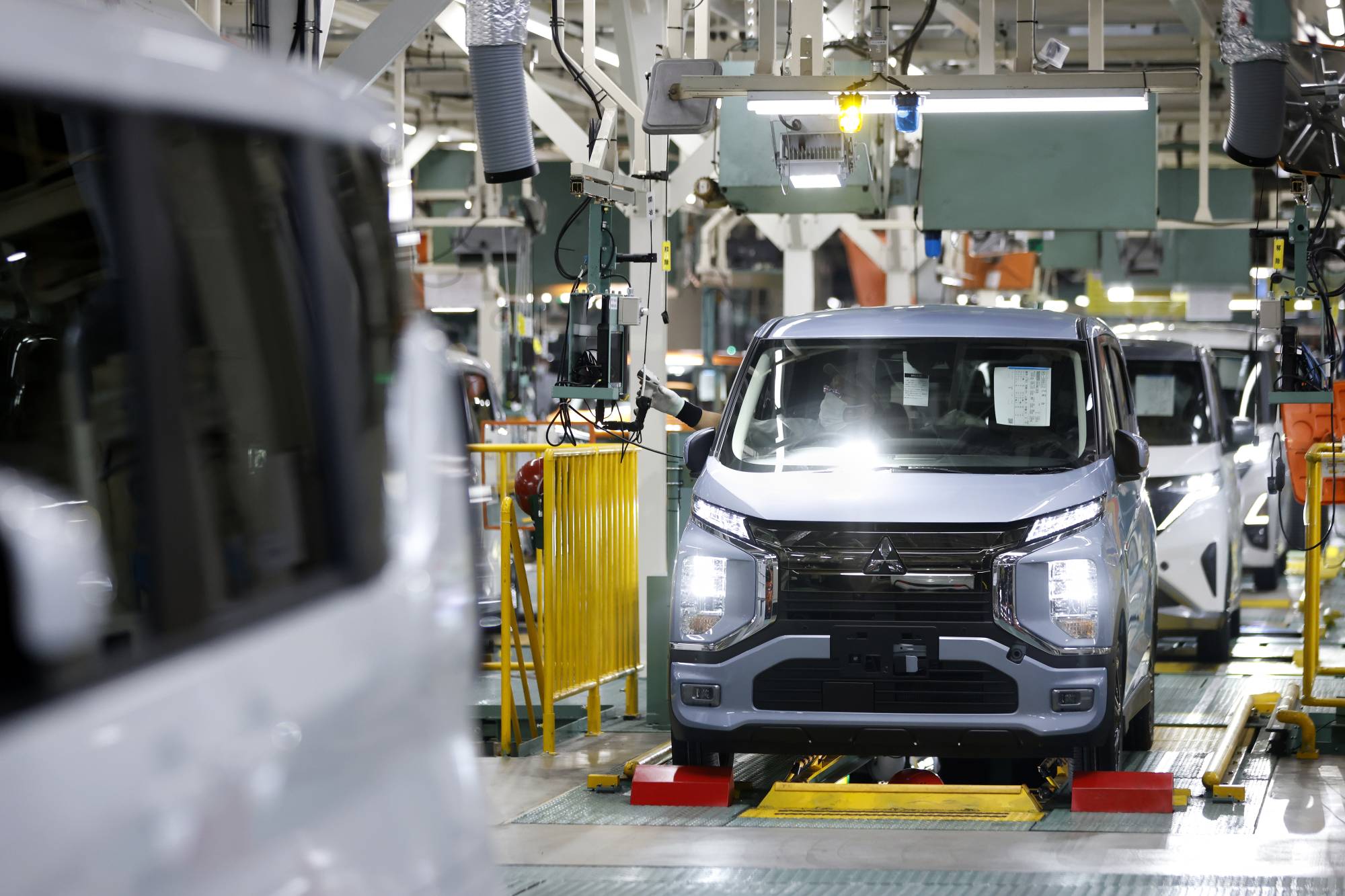 A Mitsubishi Motors eK X electric vehicle in the inspection area of the production line at the company's Mizushima plant in Kurashiki, Okayama Prefecture, on Thursday | Bloomberg