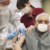 People aged 60 and older as well as individuals at high risk of developing severe symptoms if infected with COVID-19 will be eligible for the second booster shots, starting Wednesday. | KYODO
