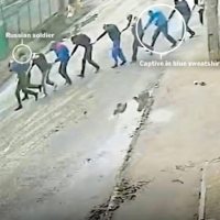 Security camera footage filmed on Yablunska Street in Bucha, Ukraine, on March 4, 2022, shows Russian paratroopers marching nine men to the parking lot of an office building they had taken as a base.  | VIA THE NEW YORK TIMES