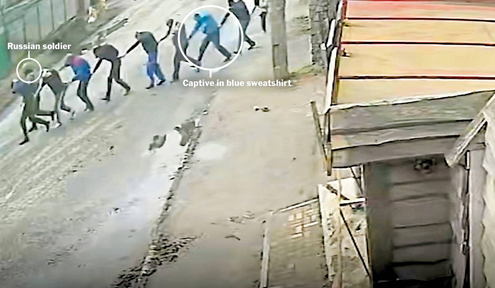Security camera footage filmed on Yablunska Street in Bucha, Ukraine, on March 4, 2022, shows Russian paratroopers marching nine men to the parking lot of an office building they had taken as a base.  | VIA THE NEW YORK TIMES