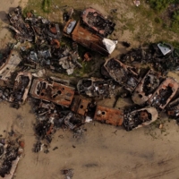 Destroyed Russian tanks and military vehicles are seen dumped in Bucha on May 16.  | REUTERS
