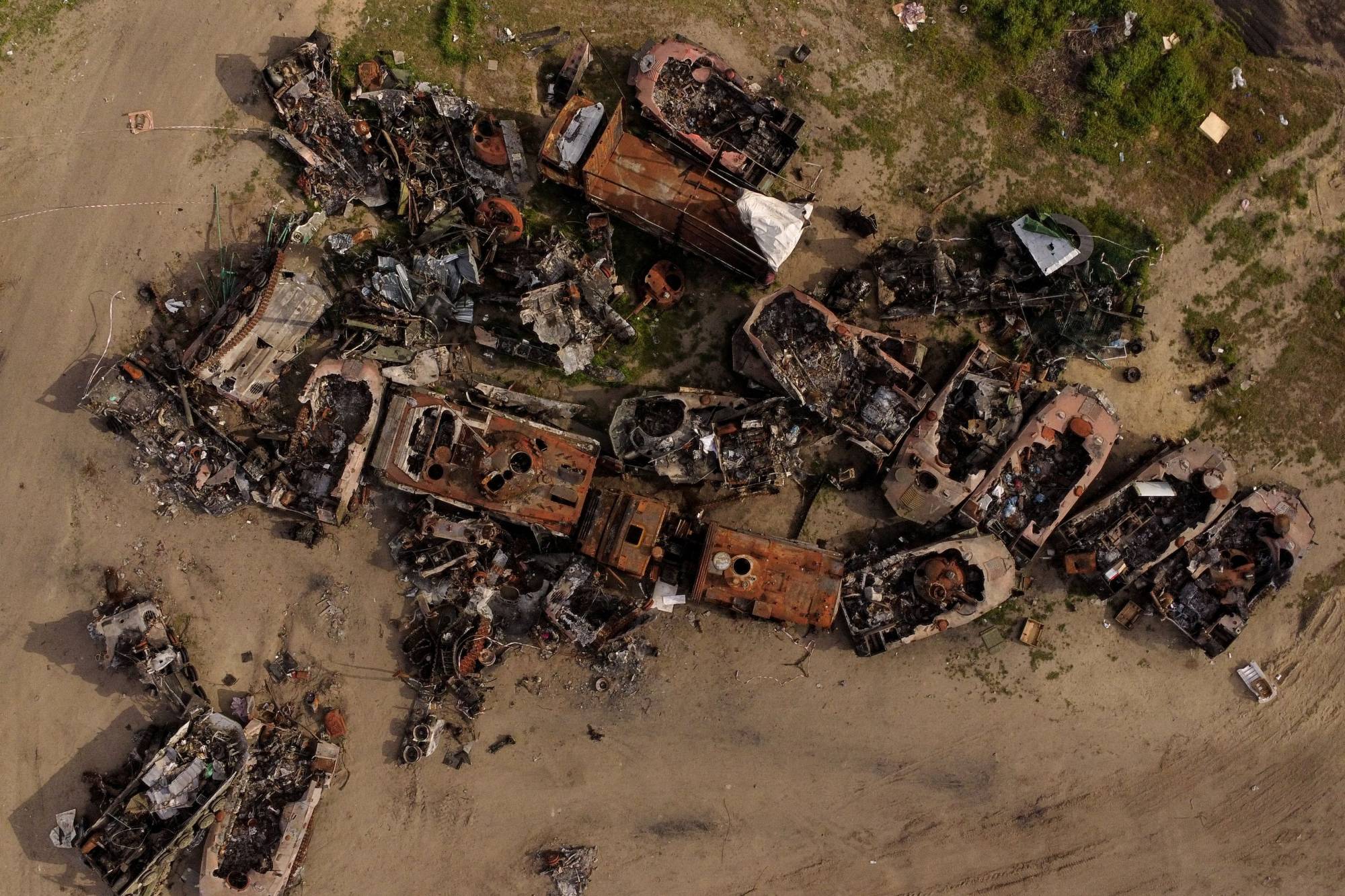Destroyed Russian tanks and military vehicles are seen dumped in Bucha on May 16. | Reuters