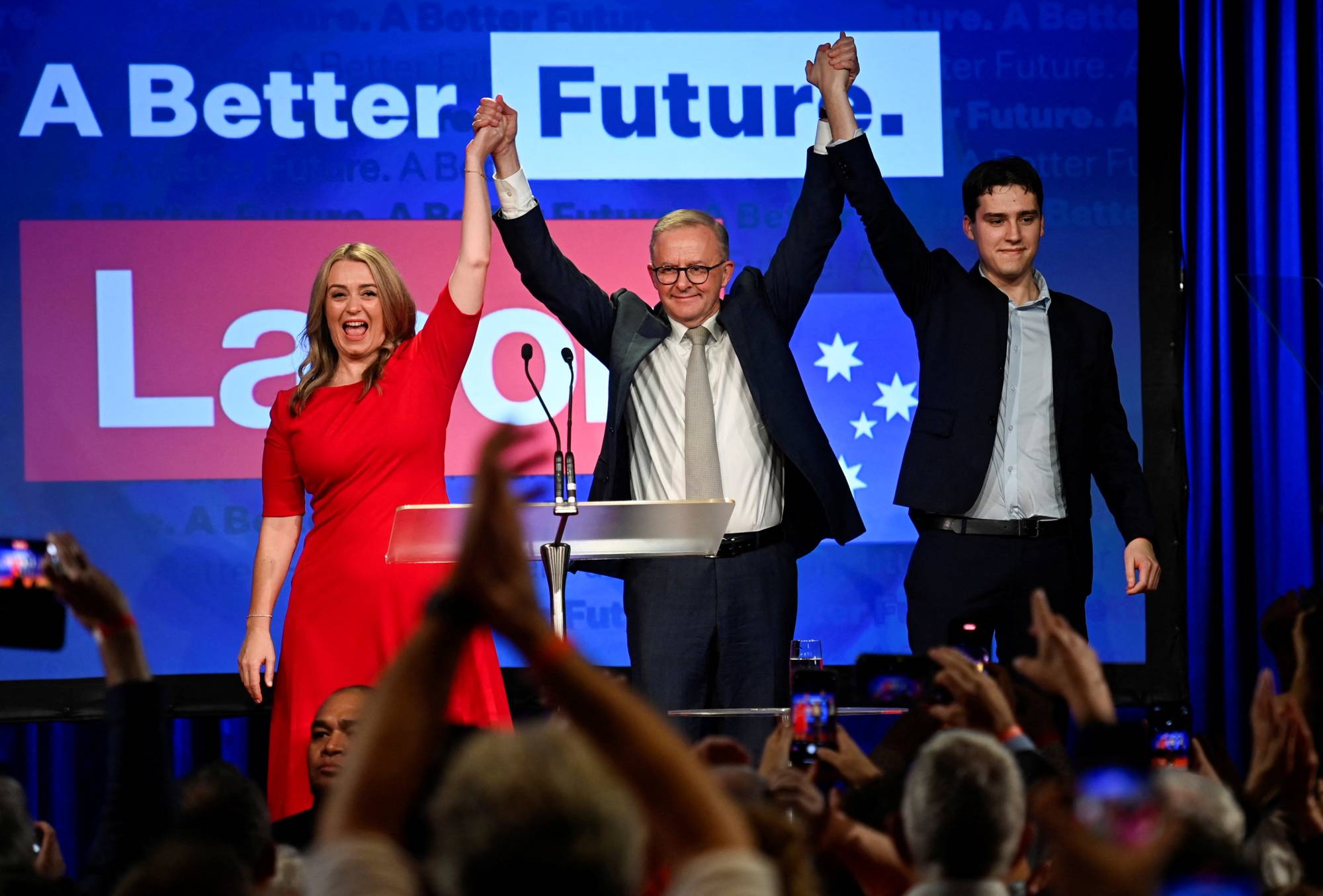 Anthony Albanese, leader of Australia's Labor Party, is accompanied by his partner Jodie Haydon and son Nathan Albanese to address his supporters in Sydney after his election victory on Saturday. | REUTERS