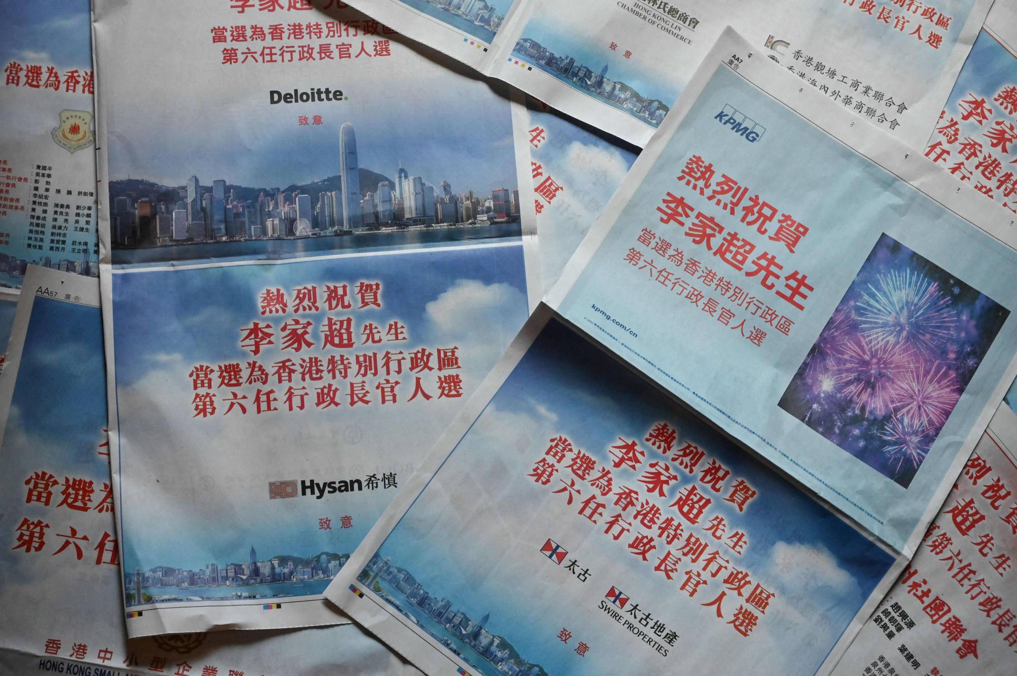 Pages from two pro-Beijing newspapers in Hong Kong filled with advertisements from leading companies and business figures praising the selection of incoming chief executive John Lee on May 9. | AFP-Jiji