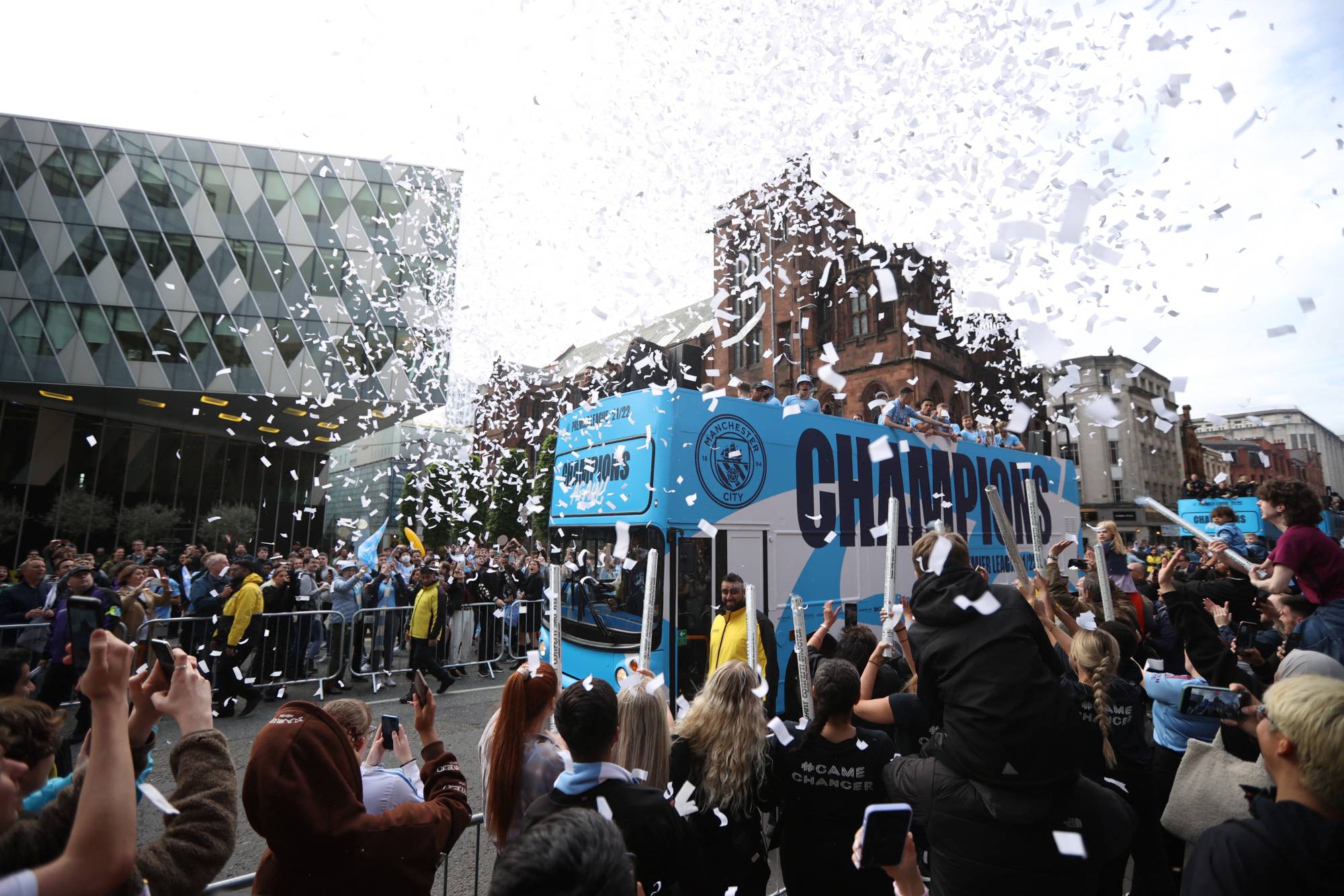 Manchester City fans celebrate the team's Premier League title during a championship parade in Manchester on Monday. | REUTERS