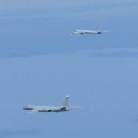 A Russian TU-95 bomber and Chinese H-6 bombers fly over the East China Sea on Tuesday.   | JOINT STAFF OFFICE OF THE DEFENSE MINISTRY OF JAPAN / VIA REUTERS 