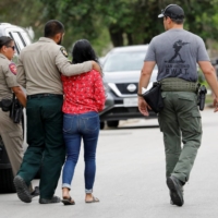 Law enforcement officers near the scene of a shooting at Robb Elementary School in Uvalde, Texas | REUTERS