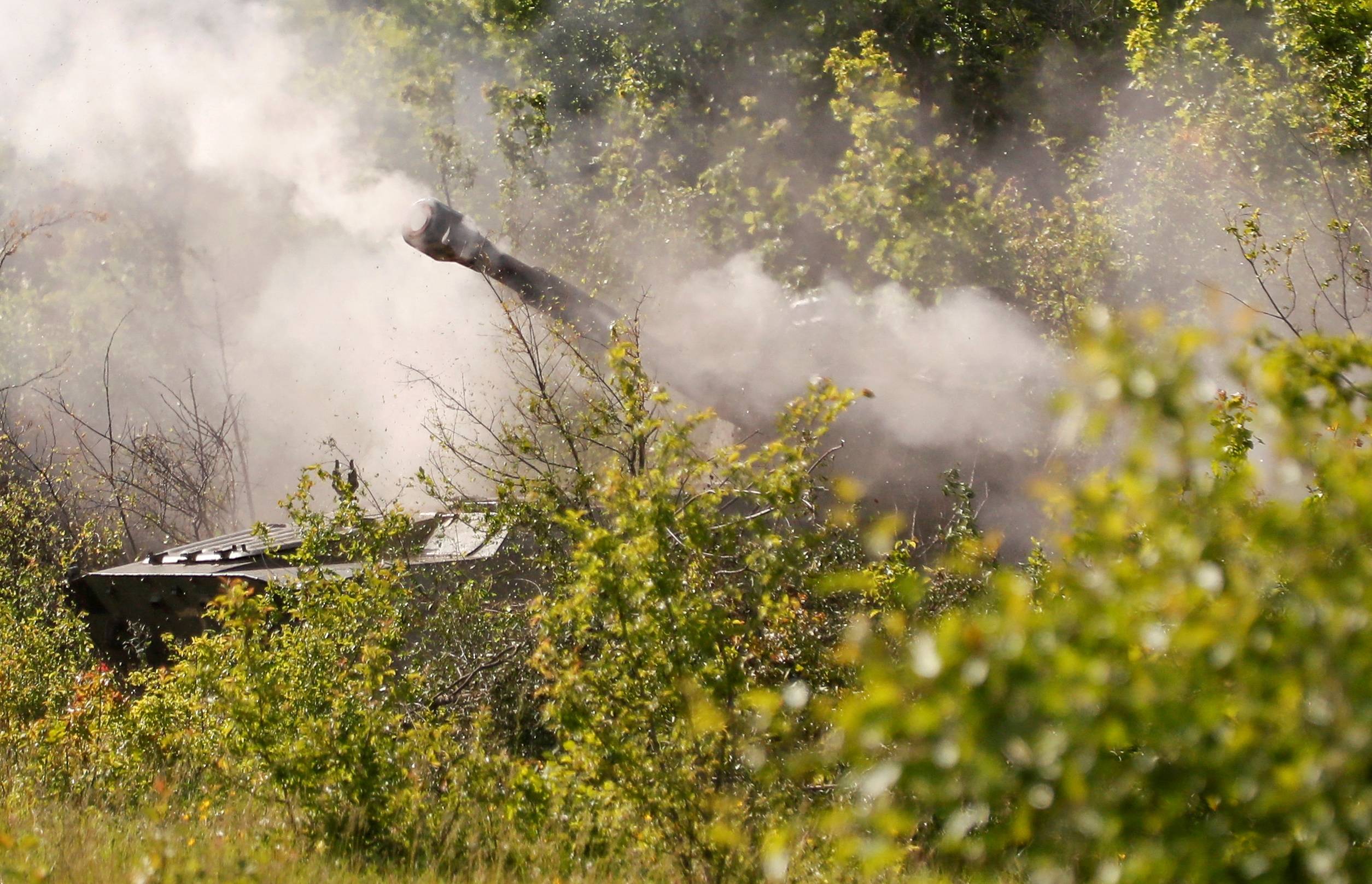 Smoke rises above a self-propelled howitzer fired by pro-Russian troops in the direction of Sievierodonetsk, Ukraine, on Tuesday.  | REUTERS