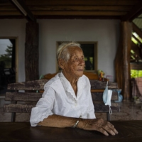 Fong Inma, now 98, who in 1944, at the age of 21, heard the crash of an American P-38 Lightning airplane, at her family\'s home in the village of Baan Mae Kua, Thailand.  | LAUREN DECICCA / THE NEW YORK TIMES