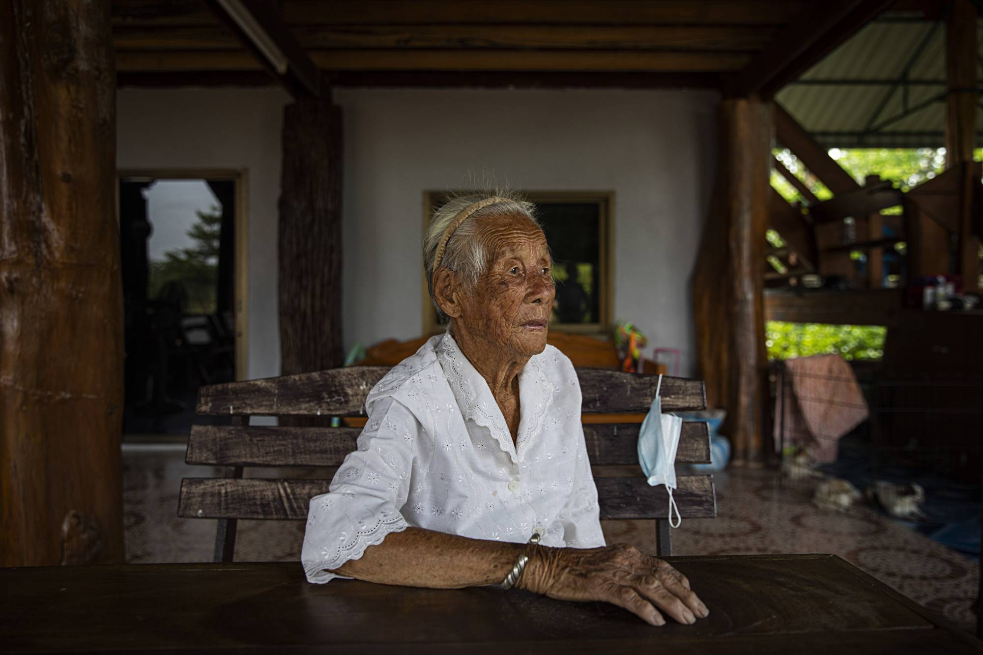 Fong Inma, now 98, who in 1944, at the age of 21, heard the crash of an American P-38 Lightning airplane, at her family's home in the village of Baan Mae Kua, Thailand. | Lauren DeCicca / The New York Times