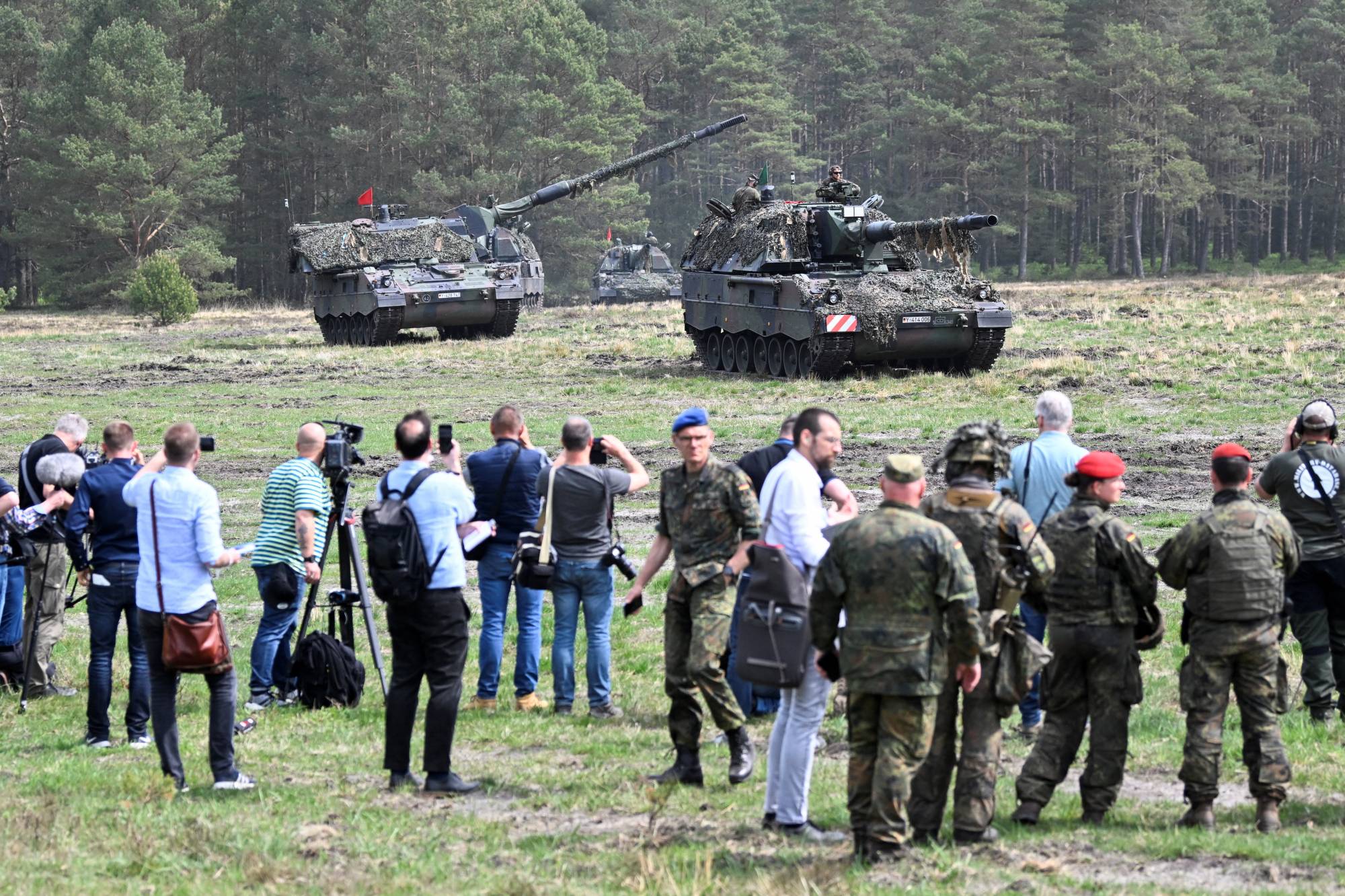 Tanks equipped with Panzerhaubitze 2000 self-propelled howitzer guns conduct training exercises at a German army base on a NATO media day in Munster, Germany, on May 10. | REUTERS