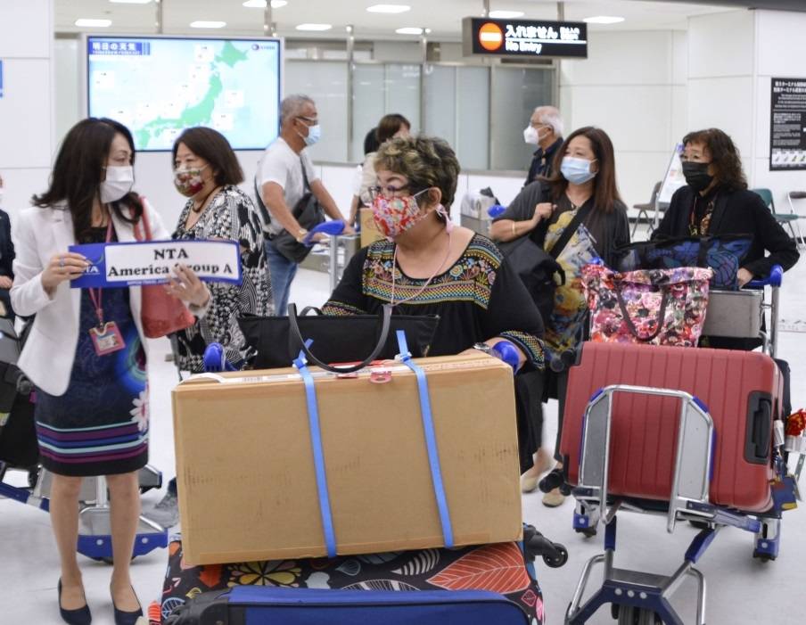 People from the United States arrive for the first small-scale test of package tours in Japan at Narita Airport near Tokyo on Tuesday. | KYODO