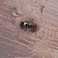 A military vehicle is pictured in a grain field previously mined with explosives, amid the Russian invasion of Ukraine, in the Chernihiv region of Ukraine, on Tuesday. | REUTERS