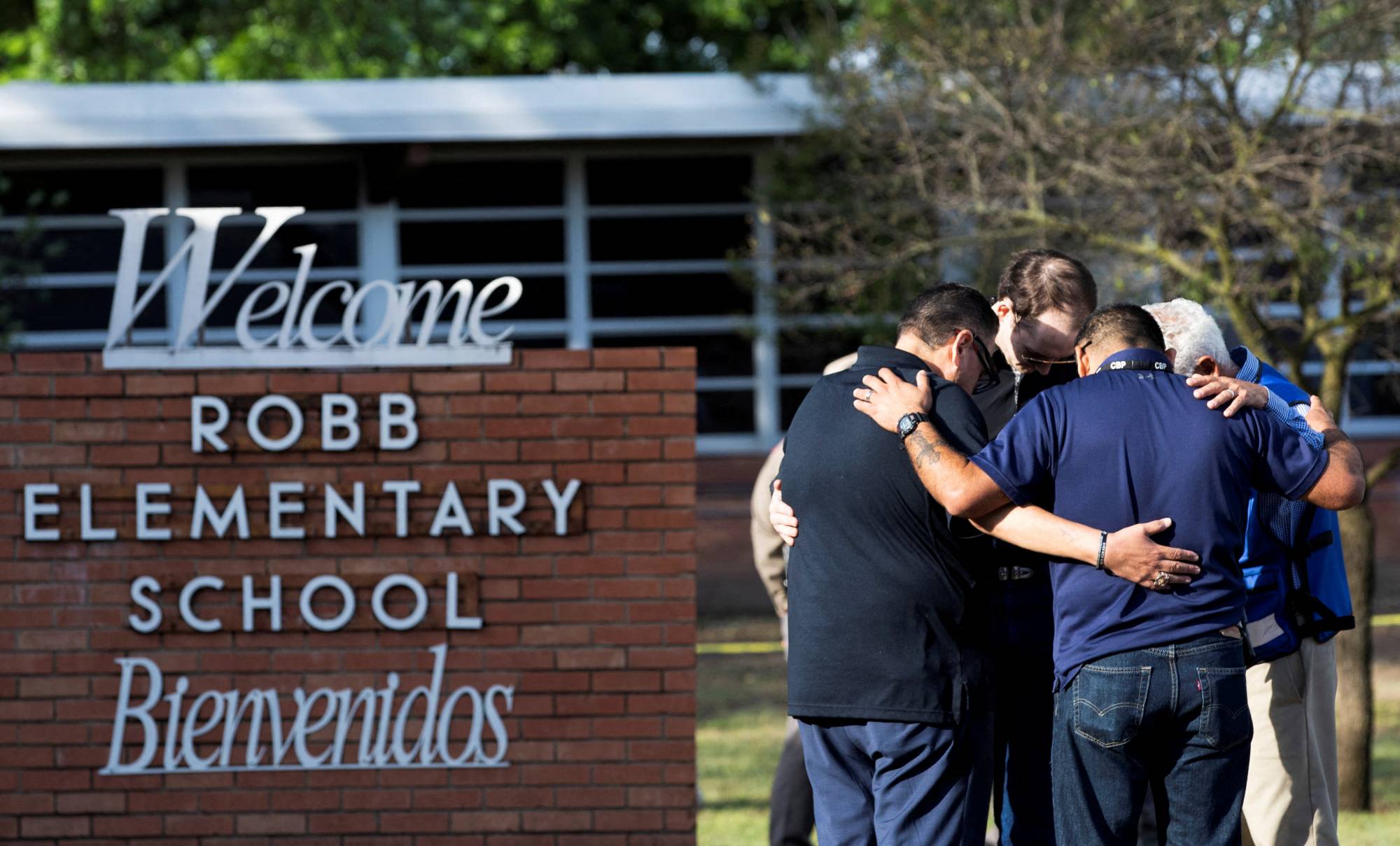 Residents gather at Robb Elementary School, the scene of a mass shooting, in Uvalde, Texas, on Wednesday. | REUTERS