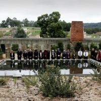 Family and friends of those who were killed at the Port Arthur massacre lay floating candles in the reflection pool at the memorial site during a service to mark the 10th anniversary of the massacre in Port Arthur, Australian, on April 28, 2006. | REUTERS