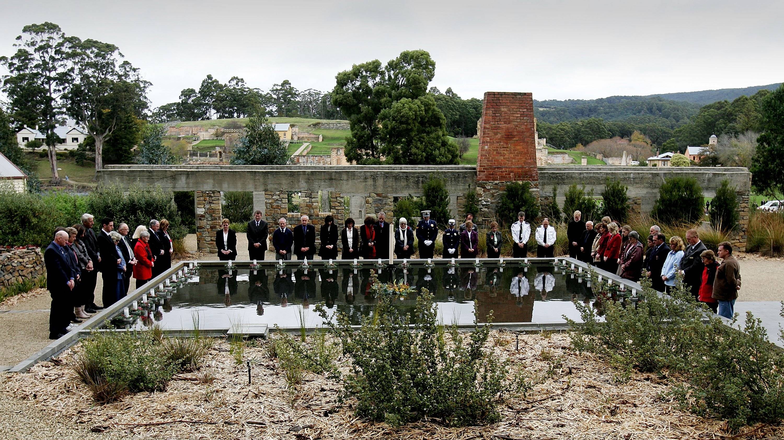 Family and friends of those who were killed at the Port Arthur massacre lay floating candles in the reflection pool at the memorial site during a service to mark the 10th anniversary of the massacre in Port Arthur, Australian, on April 28, 2006. | Reuters