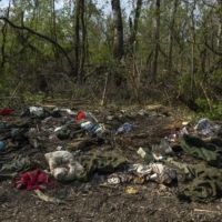 Discarded and abandoned Russian military uniforms and other personal belongings lay not far from the Seversky Donets River near Sievierodonetsk, Ukraine, on Wednesday. | IVOR PRICKETT / THE NEW YORK TIMES