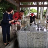 A director at Ibaraki Prefecture\'s tourism division (left) escorts tourists from Hawaii as they tour a shrine in the prefecture Thursday. | BLOOMBERG