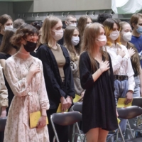 Ukrainian students who arrived in Japan after fleeing Russia\'s invasion of their country listen to Ukraine\'s national anthem during a ceremony for new students at the Japan University of Economics in Fukuoka Prefecture on April 12. | KYODO